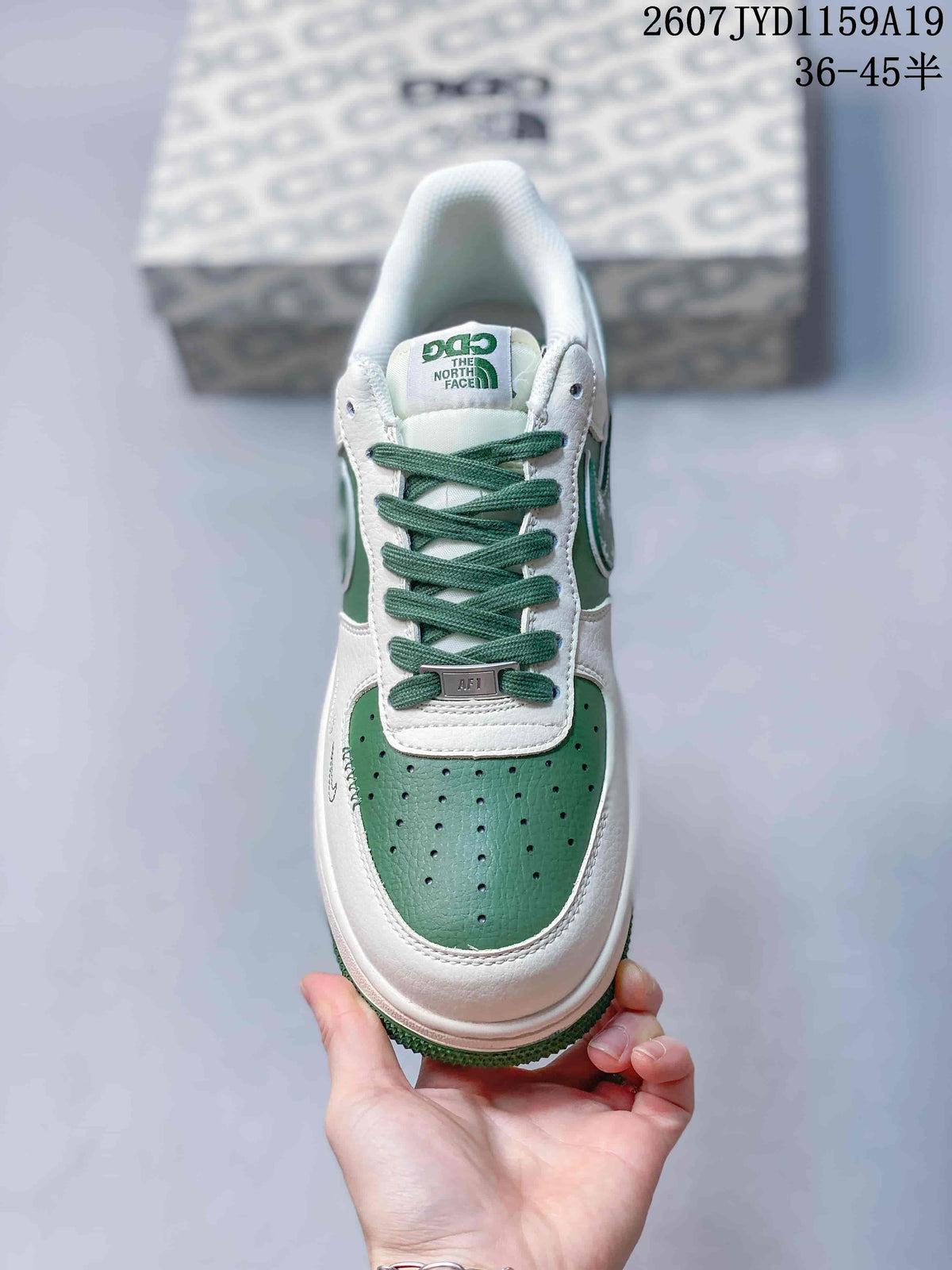Top view showing green laces, perforated green toe panel, white overlays, and tongue branding.