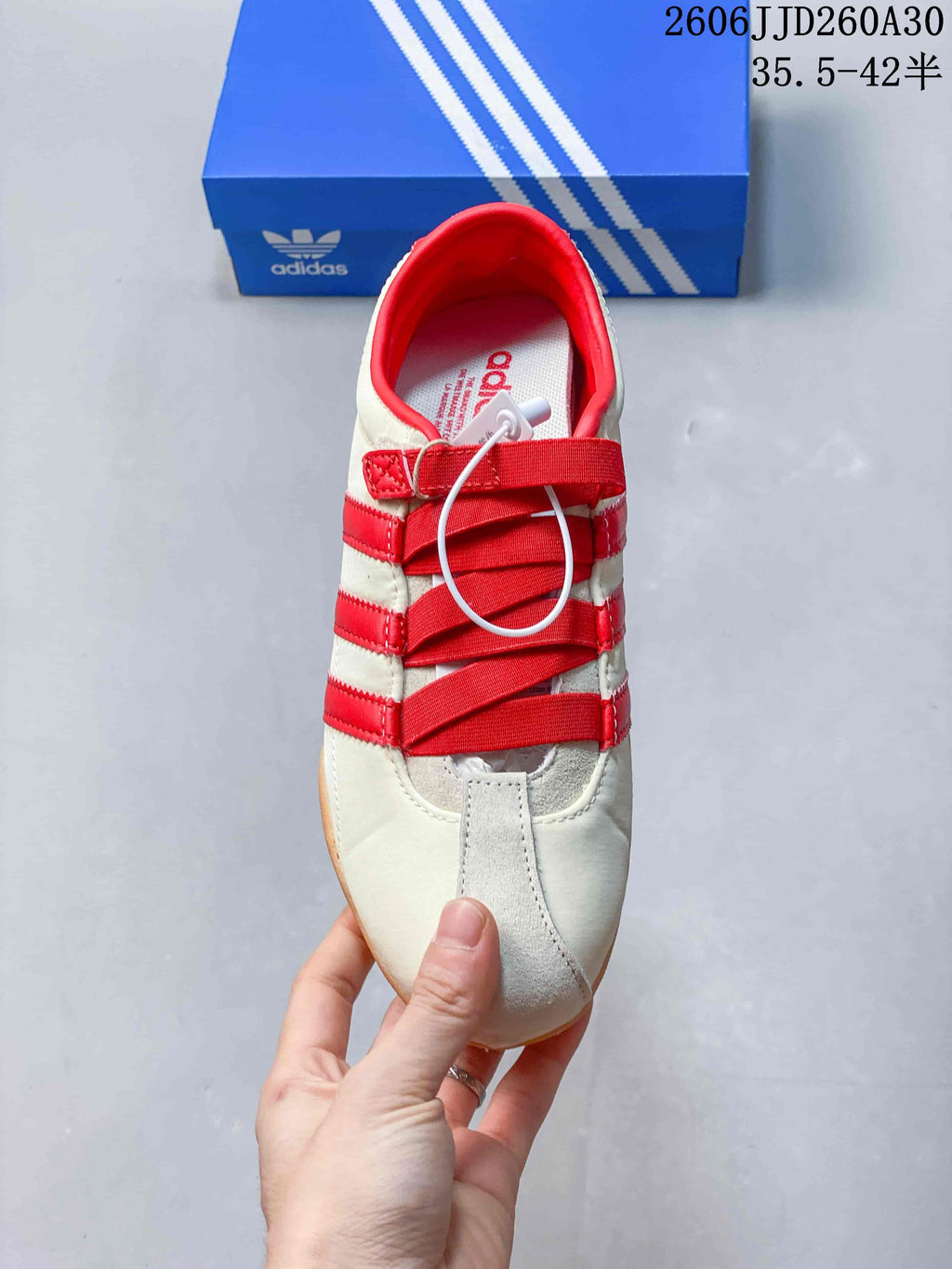 Top view showing the red straps and cream toe panel of the sneaker.