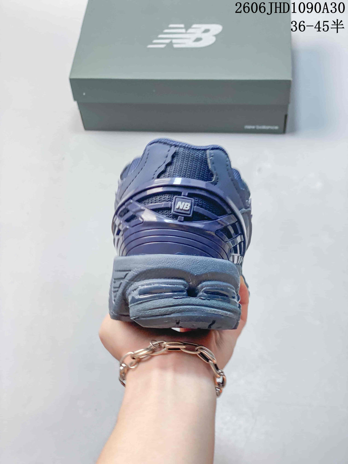 Rear view of a blue-gray New Balance sneaker showing the heel and sole.