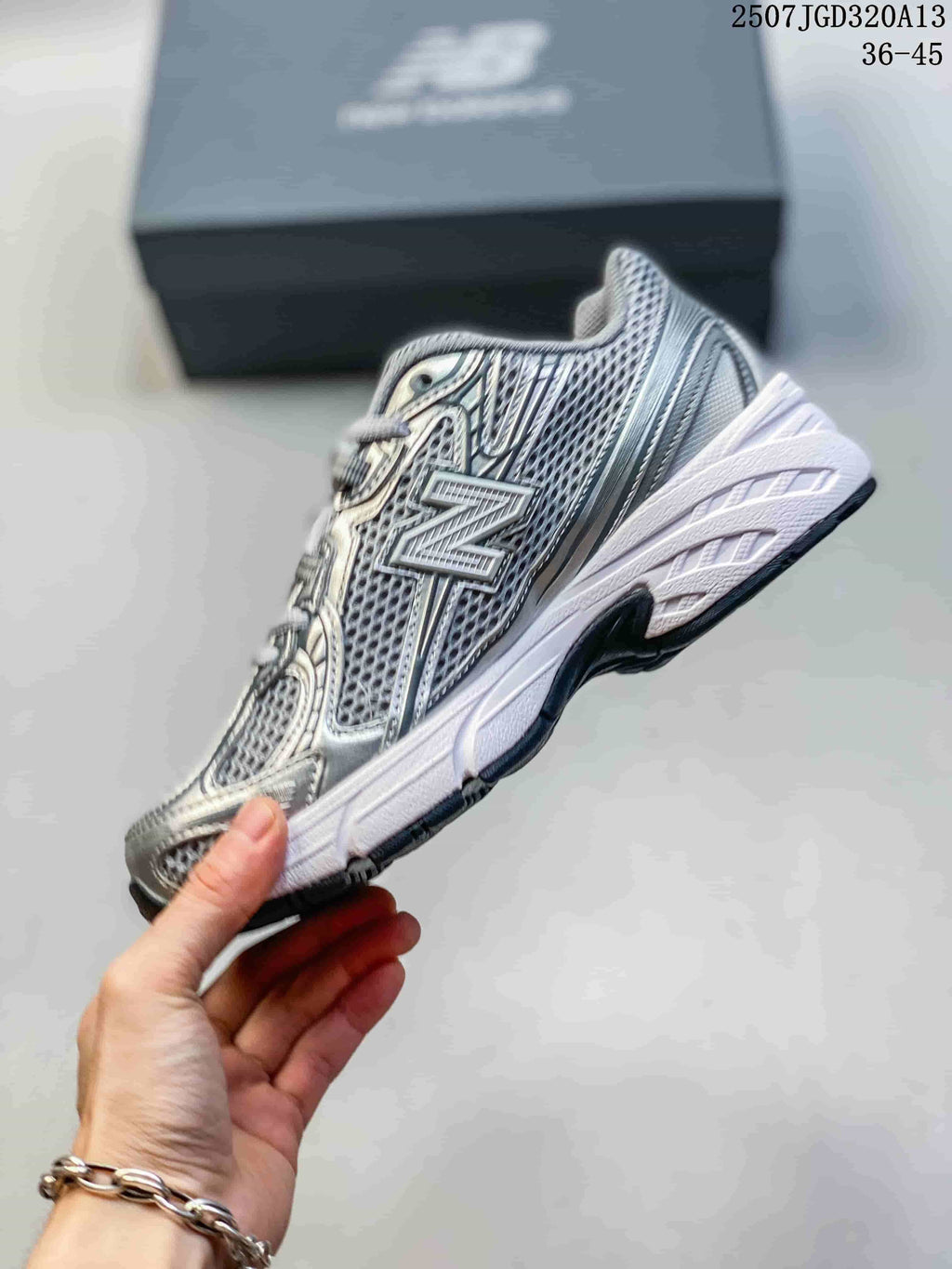 Side profile highlighting the large New Balance logo, mesh panels, and white midsole.