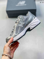 Side profile highlighting the large New Balance logo, mesh panels, and white midsole.