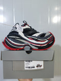 New Balance 1160 sneakers in grey, black, white and red displayed on a labeled shoe box; the box shows a photographed size C 38.