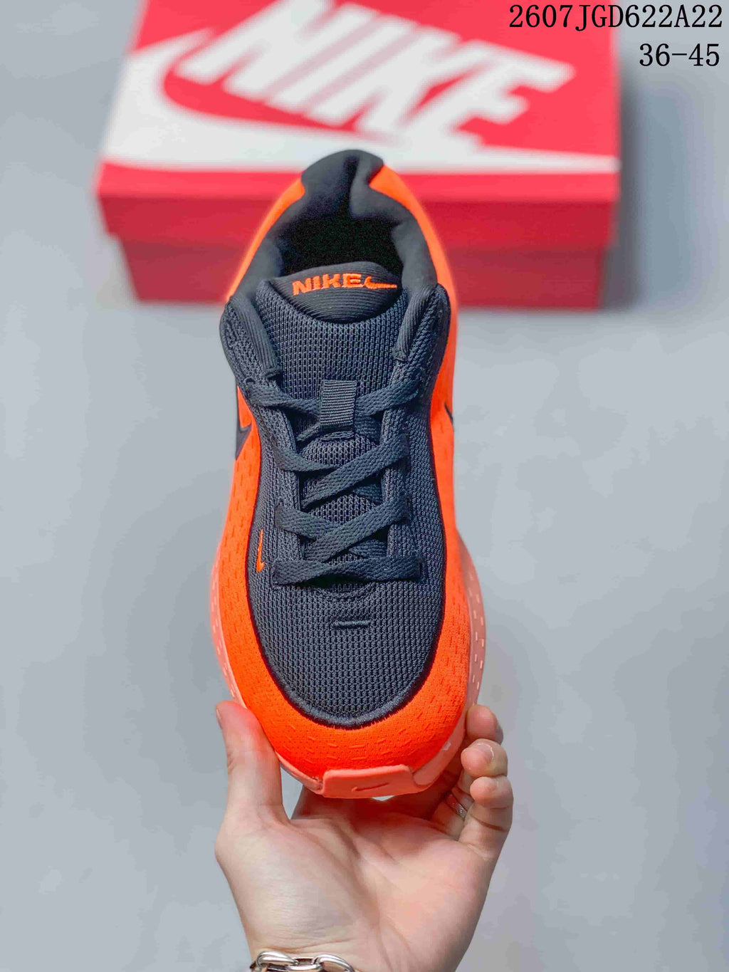 Top view showing the black mesh-style toe box, laces, tongue, and orange upper.