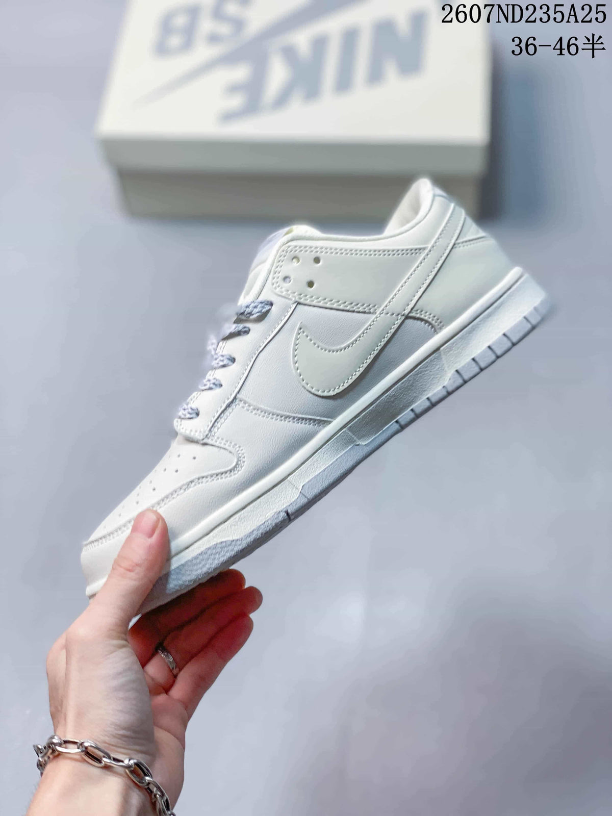 Side profile of the white low-top sneaker showing the layered panels, Swoosh detail and textured outsole.