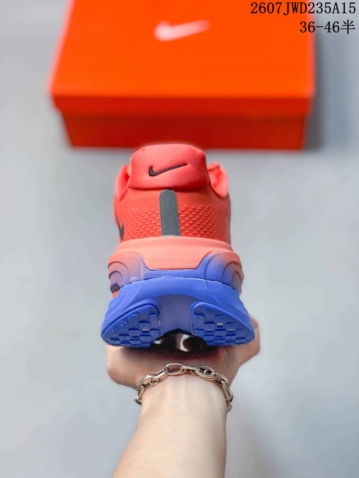 Rear view of a coral Nike running shoe showing the heel, blue outsole, and black vertical detail.