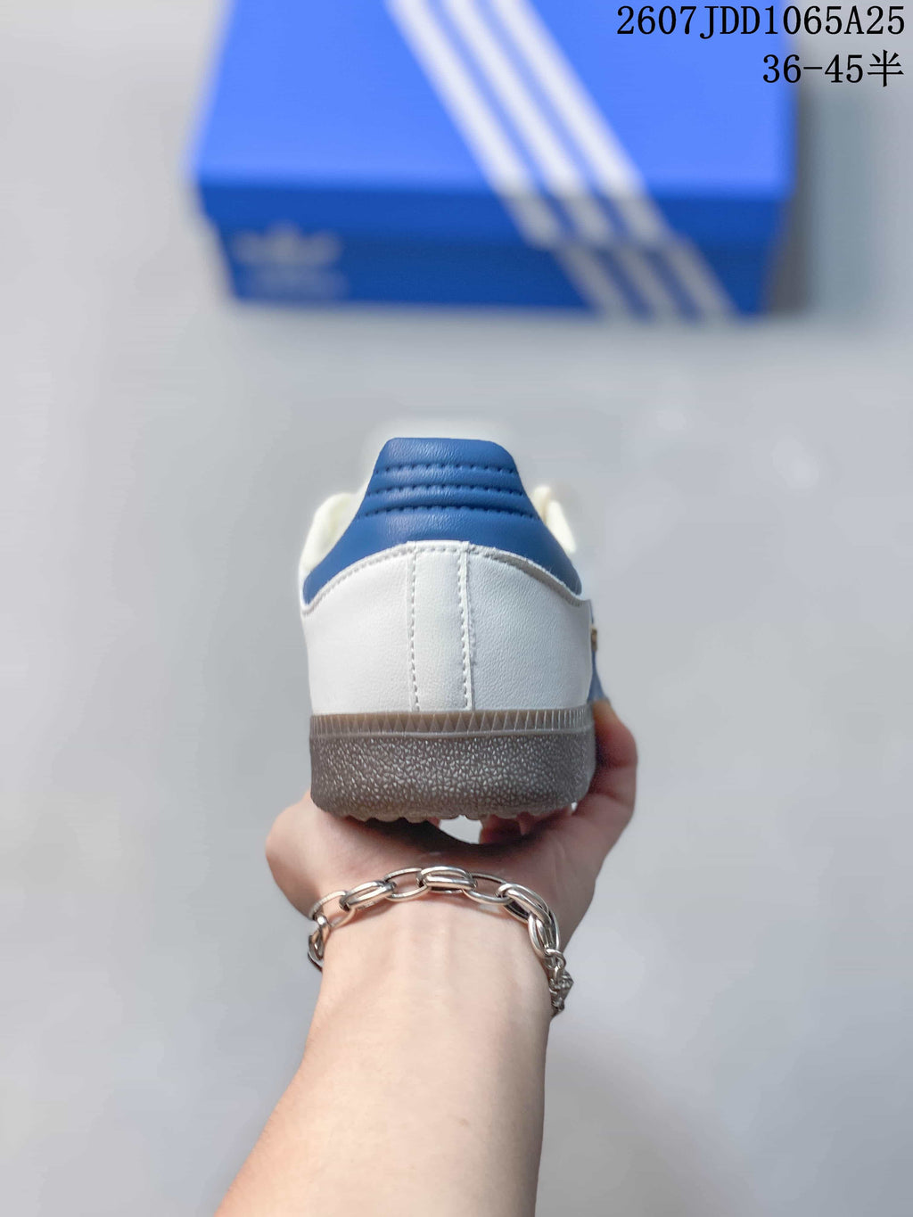 Rear view showing the white heel, blue padded collar, and gum-colored outsole.