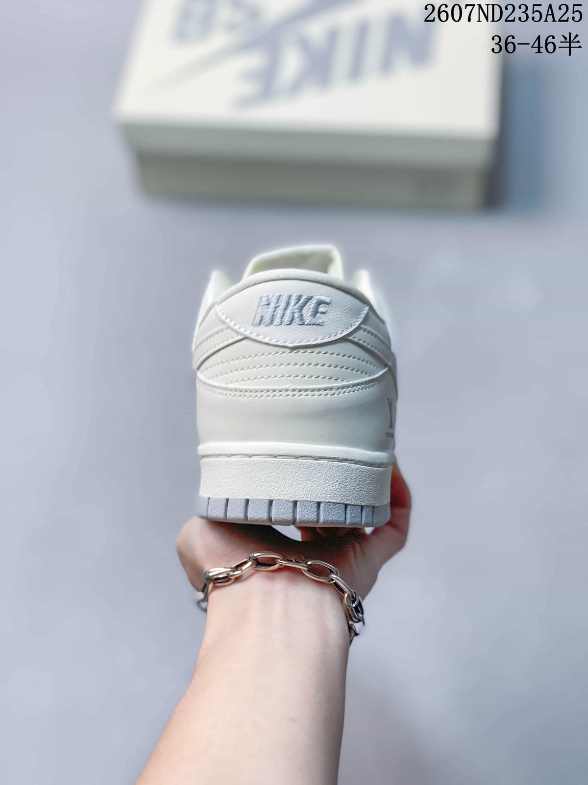Rear view of the white sneaker showing the padded heel collar and heel branding.