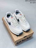 White and navy Nike ACG LDV sneakers displayed on a shoebox, with the source size range and code overlaid above.
