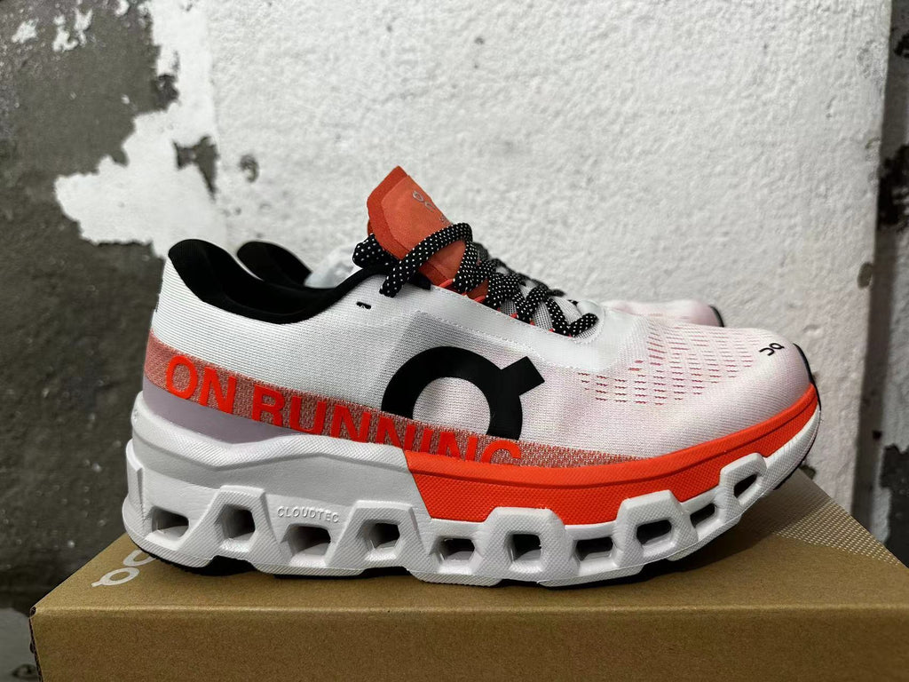 Side view of a white On Running sneaker with orange-red accents and a sculpted chunky outsole