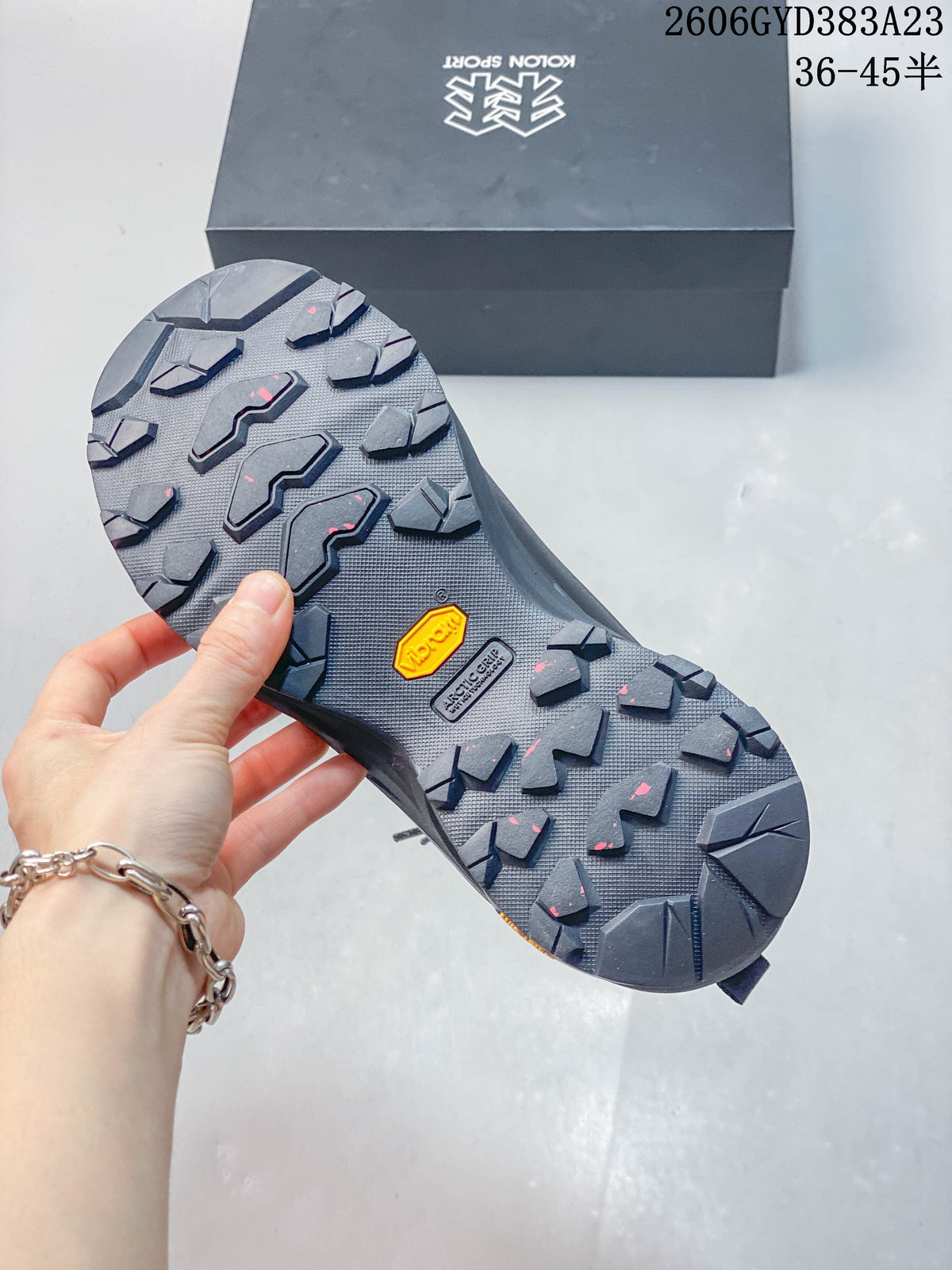 Close-up of the shoe outsole showing lugged tread and a Vibram mark