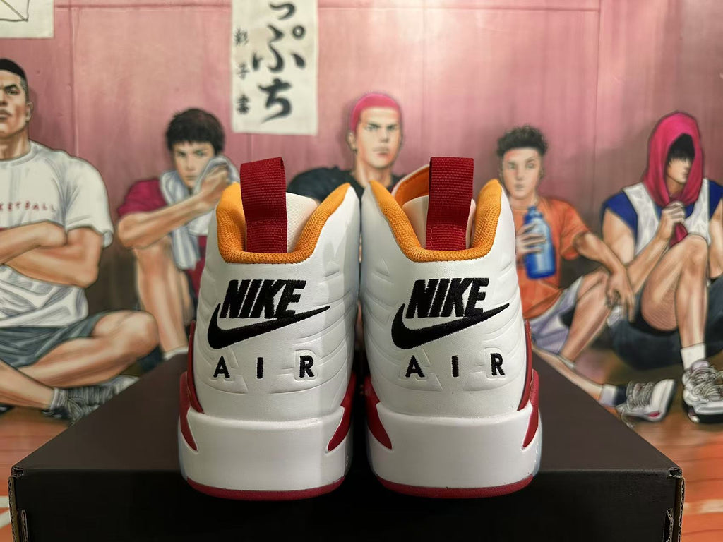 Rear view of white and red Jordan high-top sneakers with orange collar trim and heel branding.