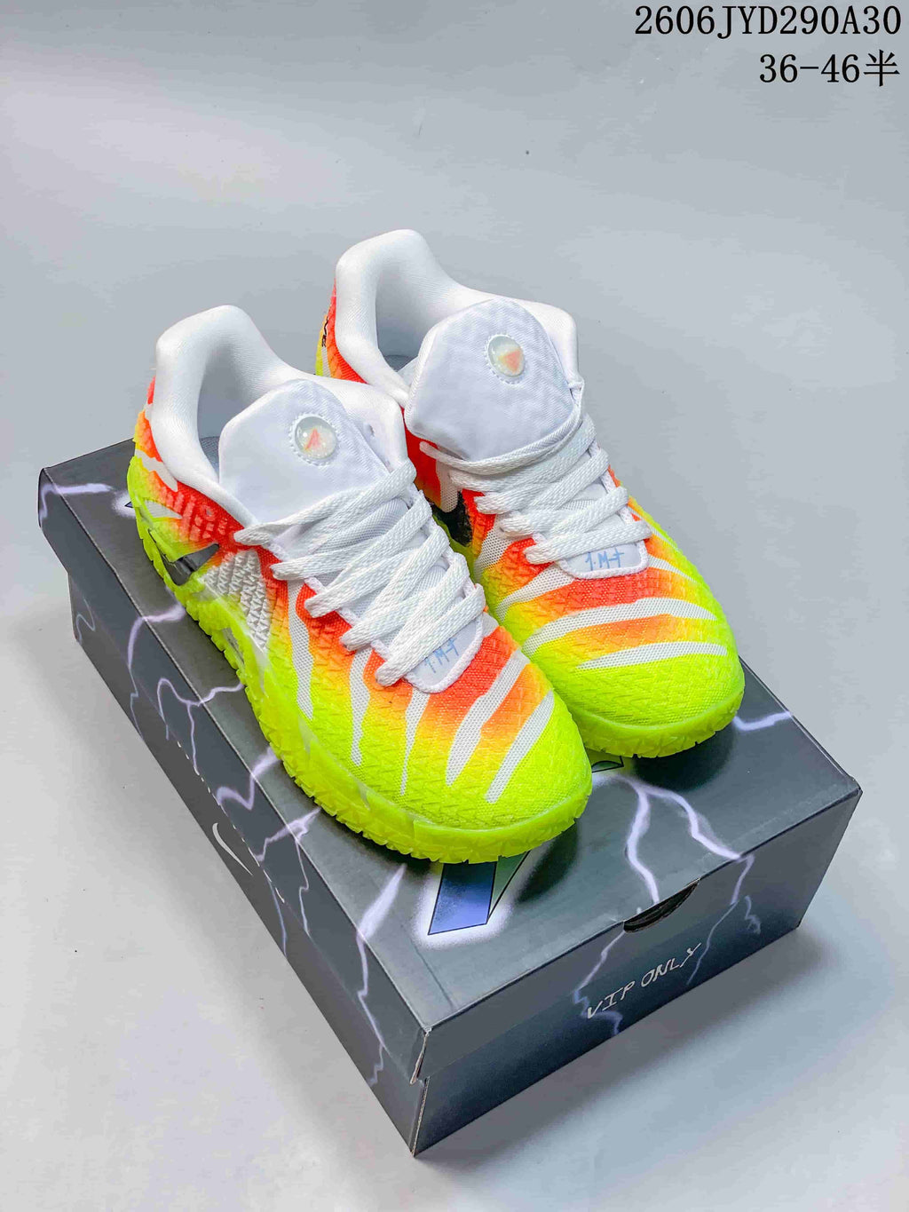 Pair of Nike Ja 3 basketball shoes in neon yellow, orange, and white, shown from the front on a shoebox.