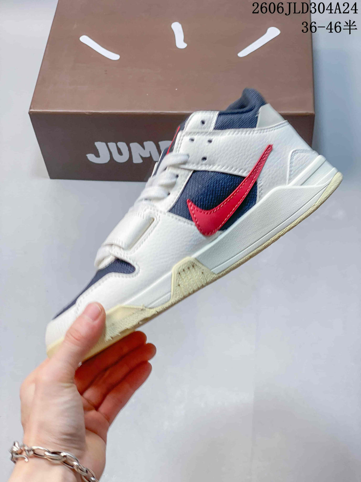 Side view showing navy panels, red accent, and forefoot strap