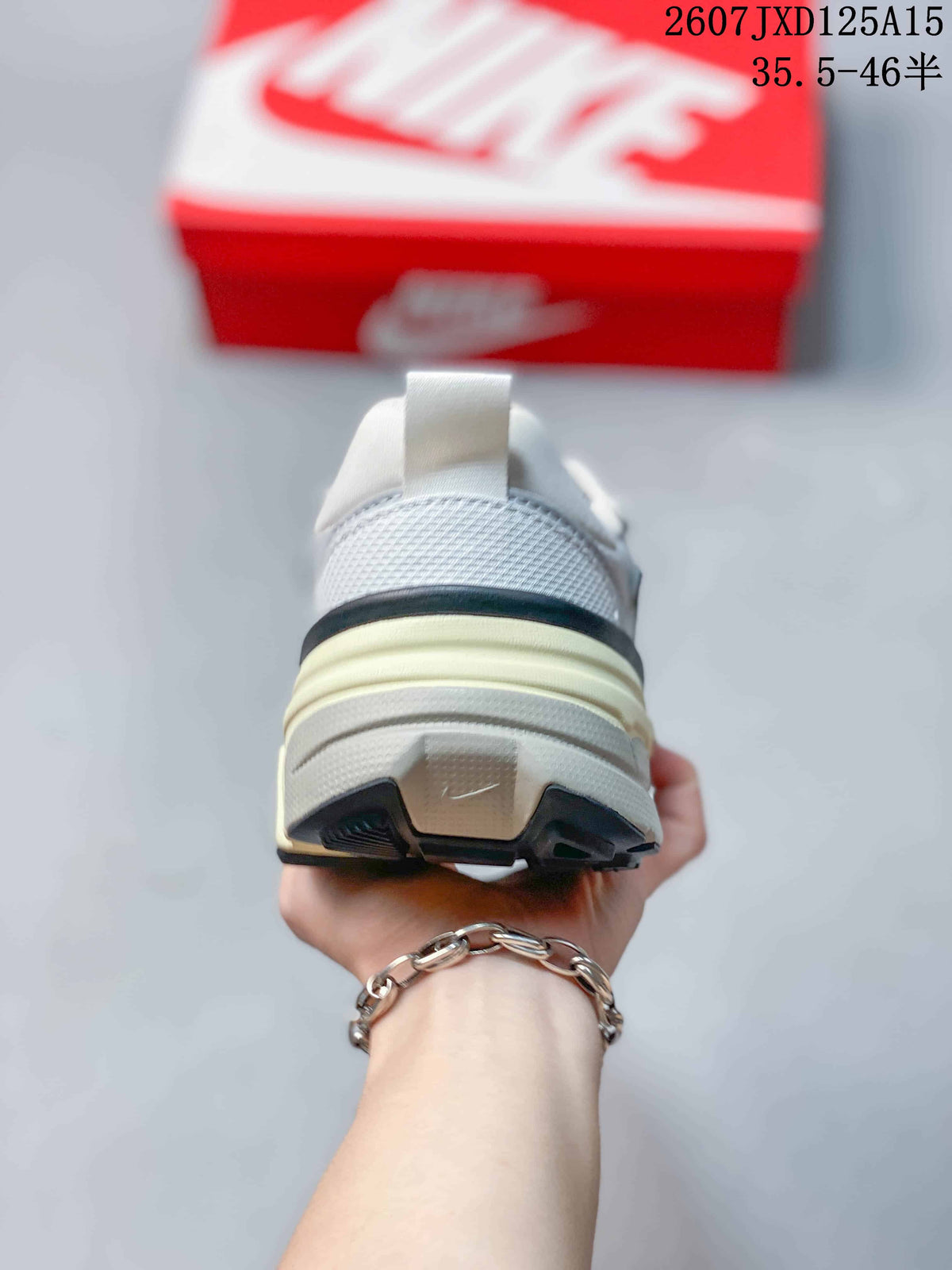Rear view of the sneaker showing the padded heel, pull tab, layered cream midsole and black outsole accents.
