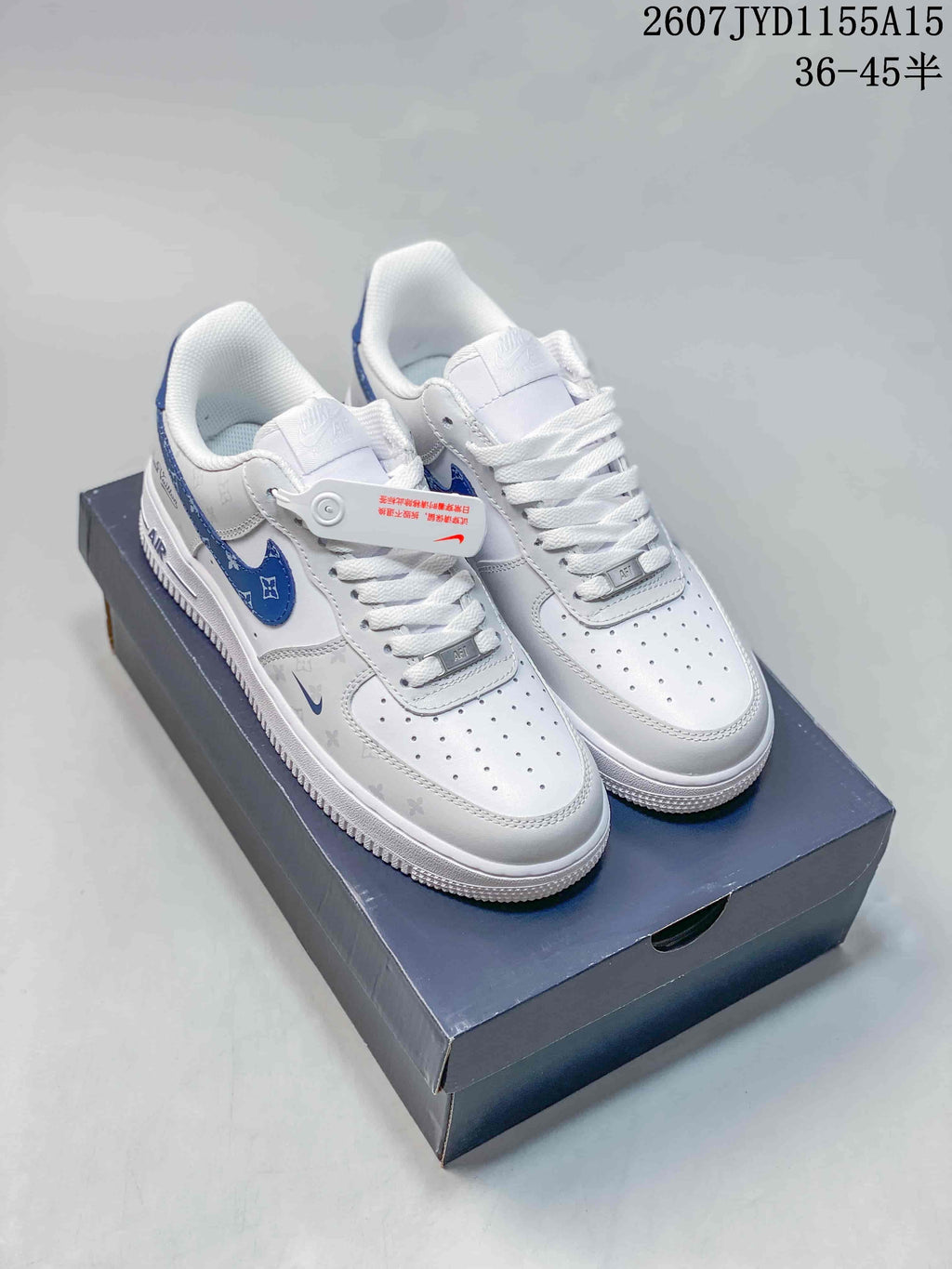 Pair of white and blue Nike Air Force 1 sneakers displayed on a shoebox.