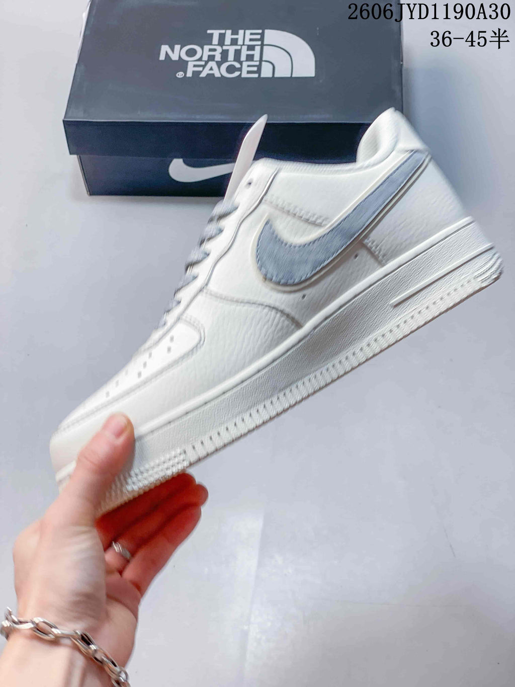 Side view showing the gray Swoosh and off-white low-top design