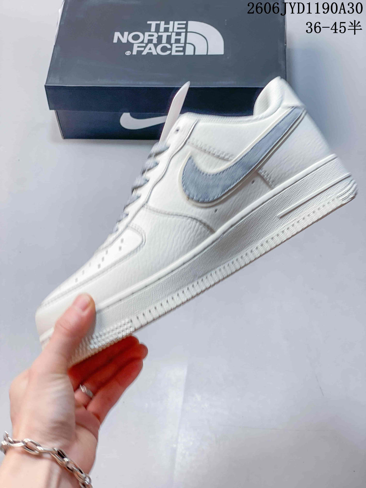 Side view showing the gray Swoosh and off-white low-top design