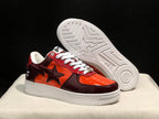 Three-quarter view with one sneaker lifted to reveal the white outsole pattern and central star motif.