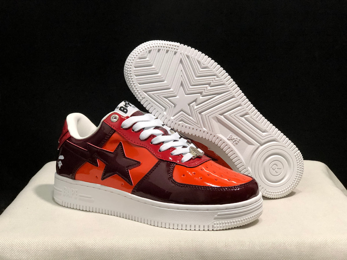 Three-quarter view with one sneaker lifted to reveal the white outsole pattern and central star motif.