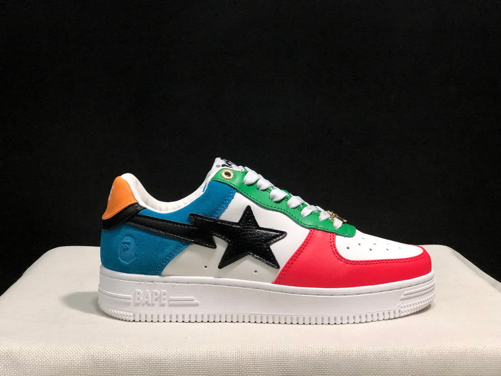 Side profile close-up showing the red toe, blue heel, green lace panel, black star detail, and raised BAPE outsole branding.