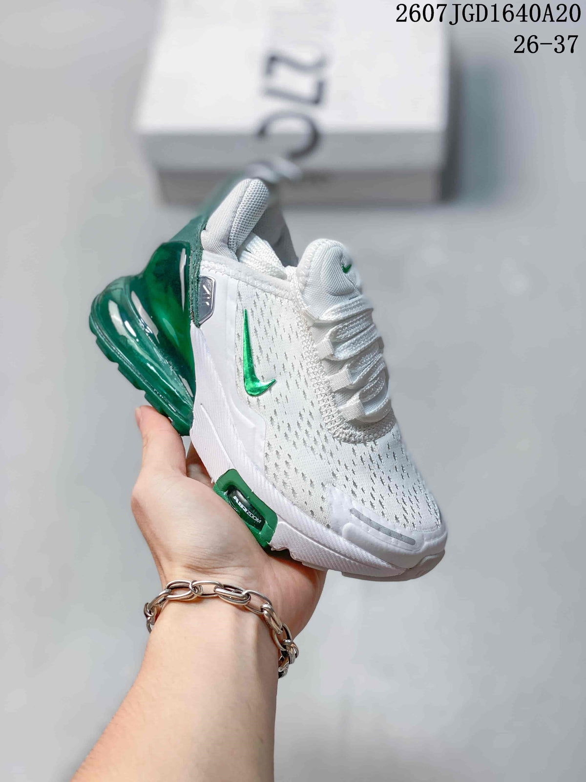 Angled side view showing the white upper, green Swoosh and translucent green heel unit.