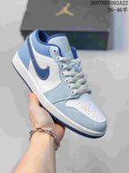Angled side view highlighting the low-top shape, light blue overlays, white panels, dark blue side branding, and blue outsole.