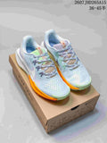 Pair of Nike Pegasus Trail 5 sneakers in light blue with lime green and orange accents, displayed on a shoe box.