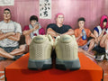 Rear view of light beige and gray Nike shoes with perforated heel panels.
