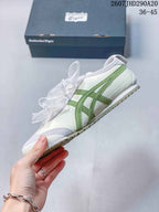 Side view highlighting the white upper, green layered stripes, light gray overlays, and ribbon laces.