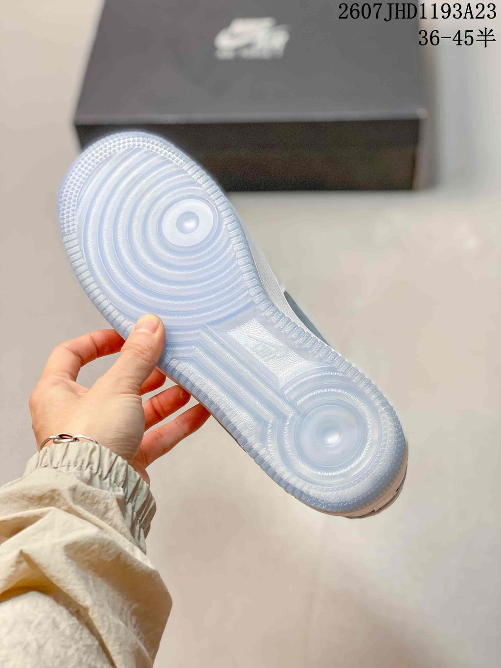 Underside view showing the translucent blue outsole with concentric traction patterns.