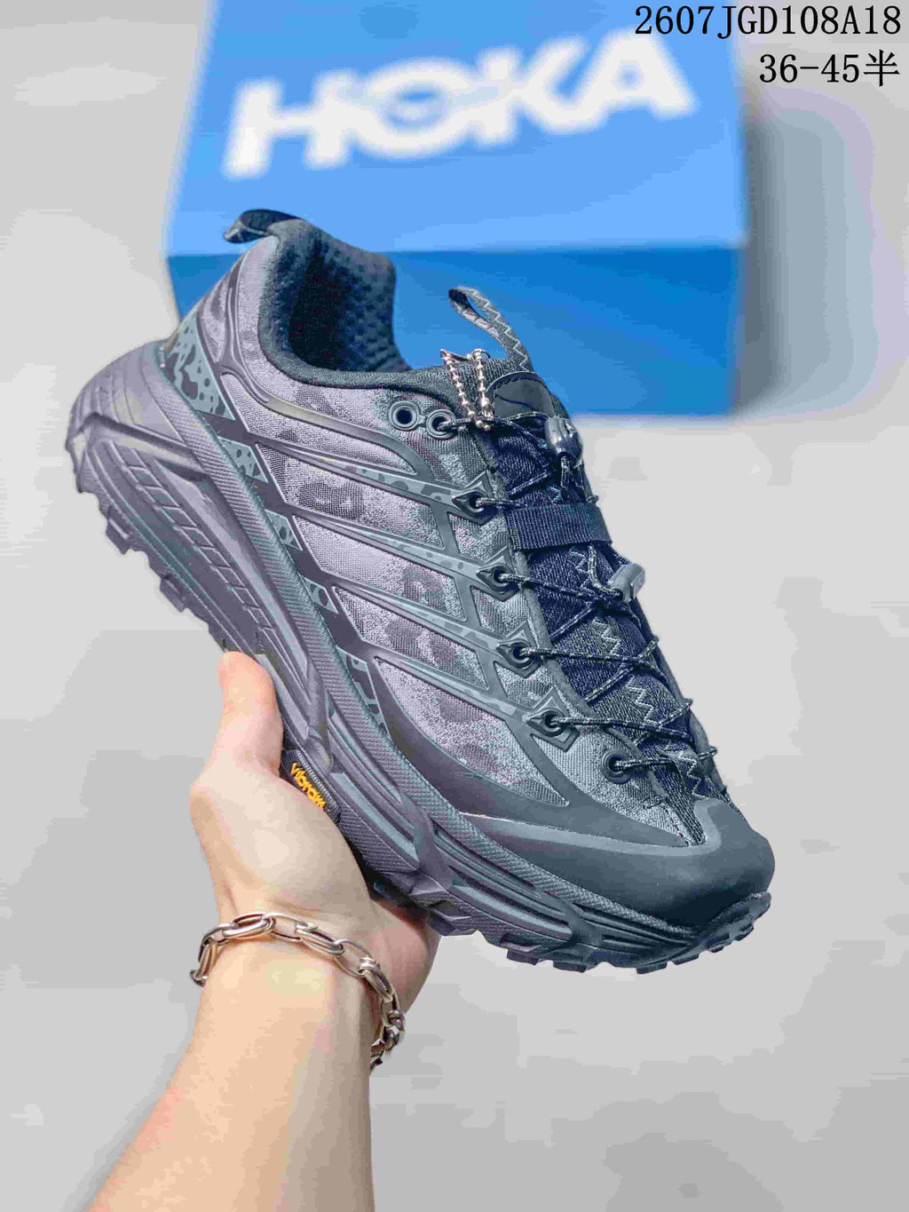 Dark charcoal HOKA Mafate Speed 2 sneaker shown from the side and top, with a textured upper and lugged outsole.