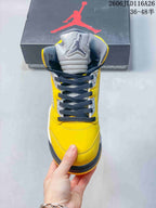 Front view of the high-top sneaker with dark laces and a gray tongue