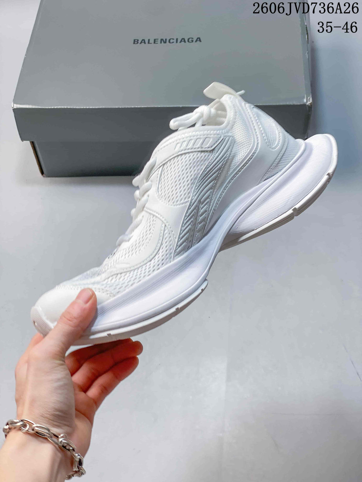 Side view of a white mesh sneaker with layered panels and a thick sculpted sole.
