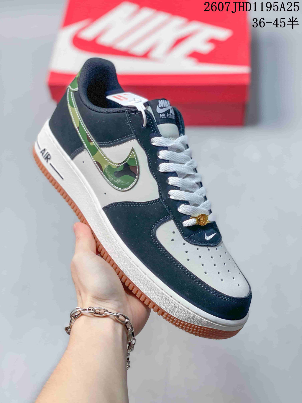 Angled side view of the navy and white low-top sneaker with camouflage-patterned Swoosh detailing and gum outsole.