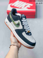 Angled side view of the navy and white low-top sneaker with camouflage-patterned Swoosh detailing and gum outsole.