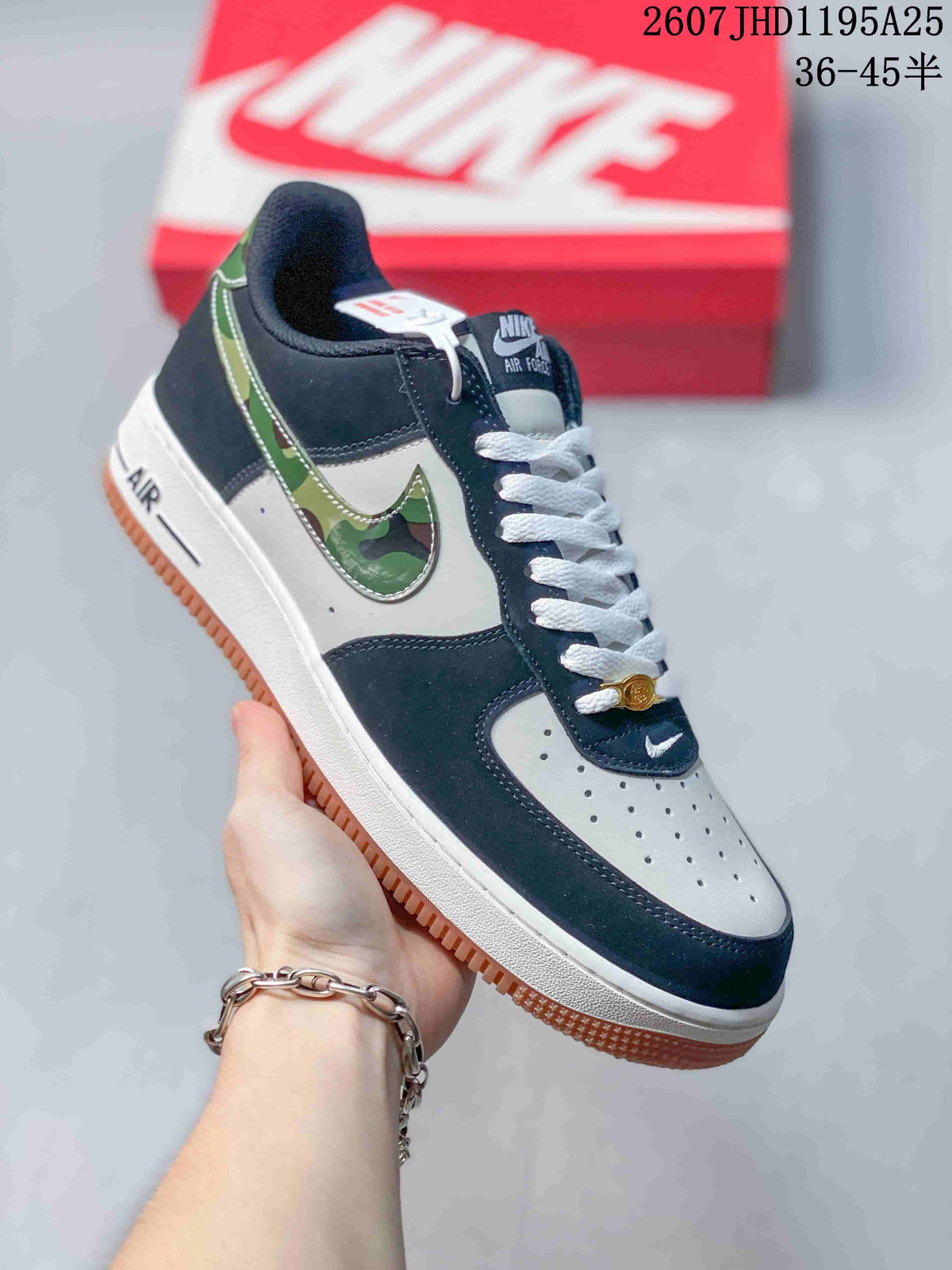 Angled side view of the navy and white low-top sneaker with camouflage-patterned Swoosh detailing and gum outsole.