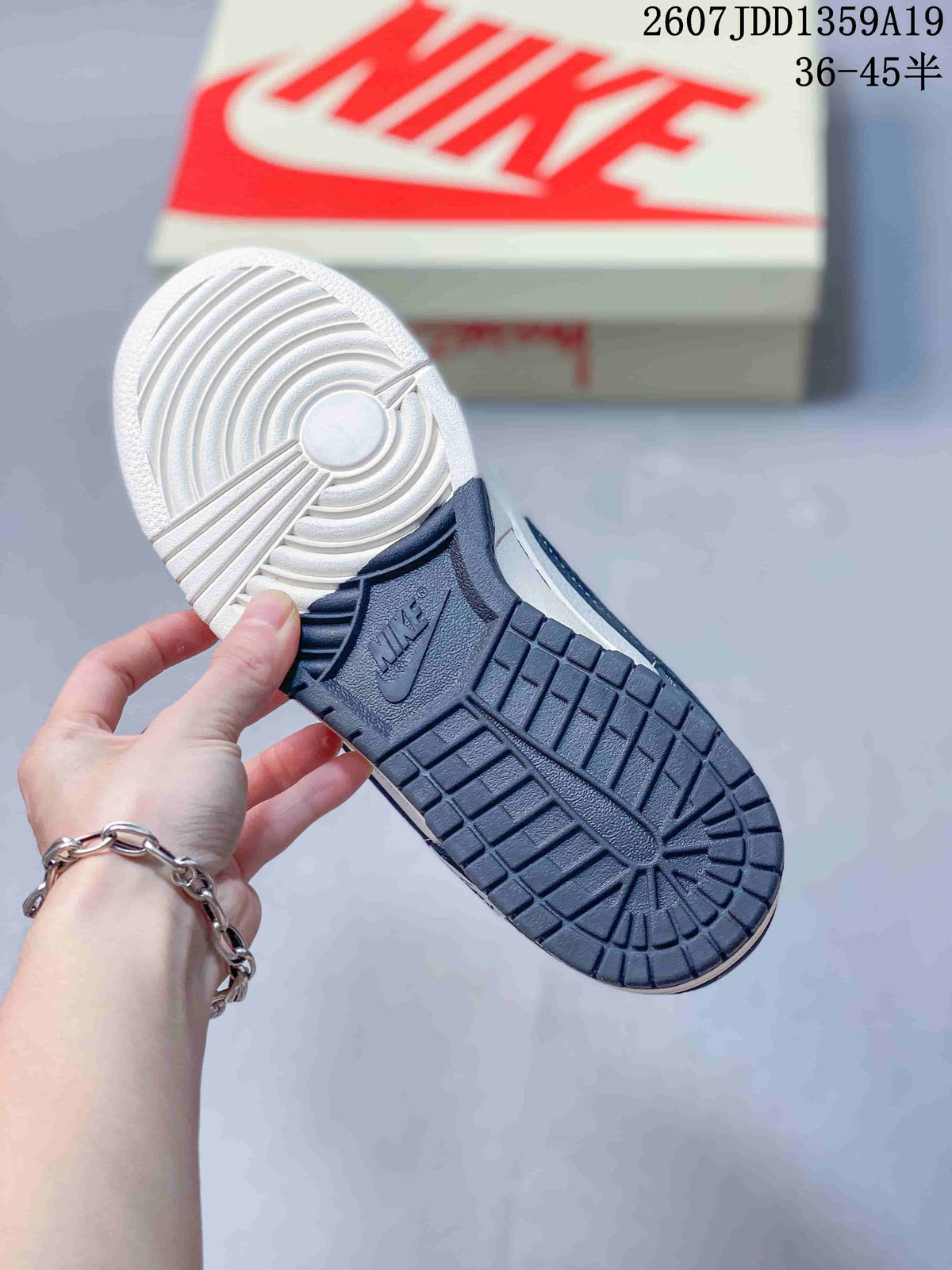 Underside view showing the navy and white rubber outsole with circular traction detailing.