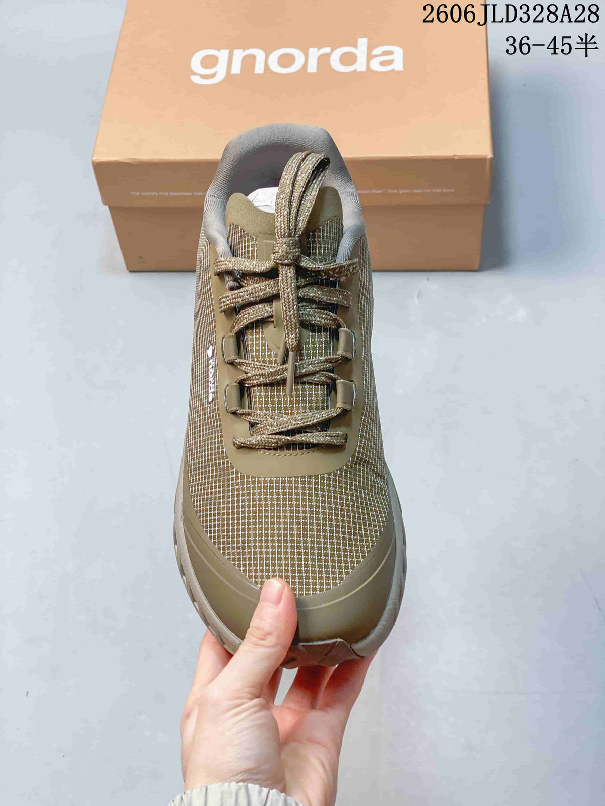 Front view of an olive hiking shoe showing its grid-patterned upper and lacing.