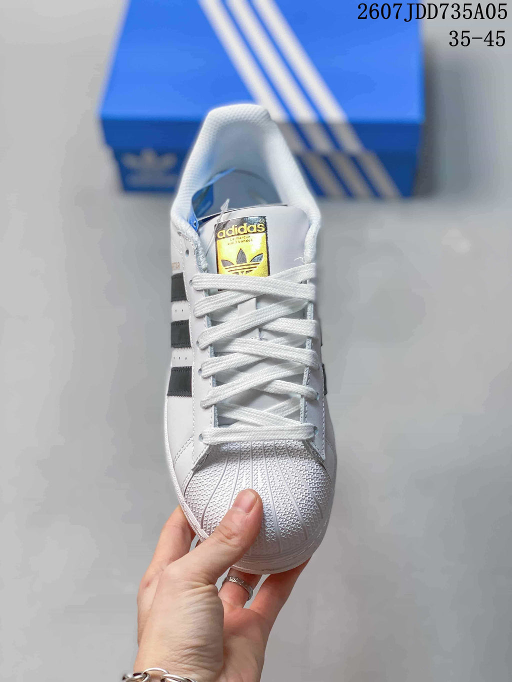 Front view showing white laces, the Adidas tongue label, and textured shell-style toe.