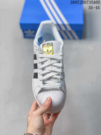 Front view showing white laces, the Adidas tongue label, and textured shell-style toe.