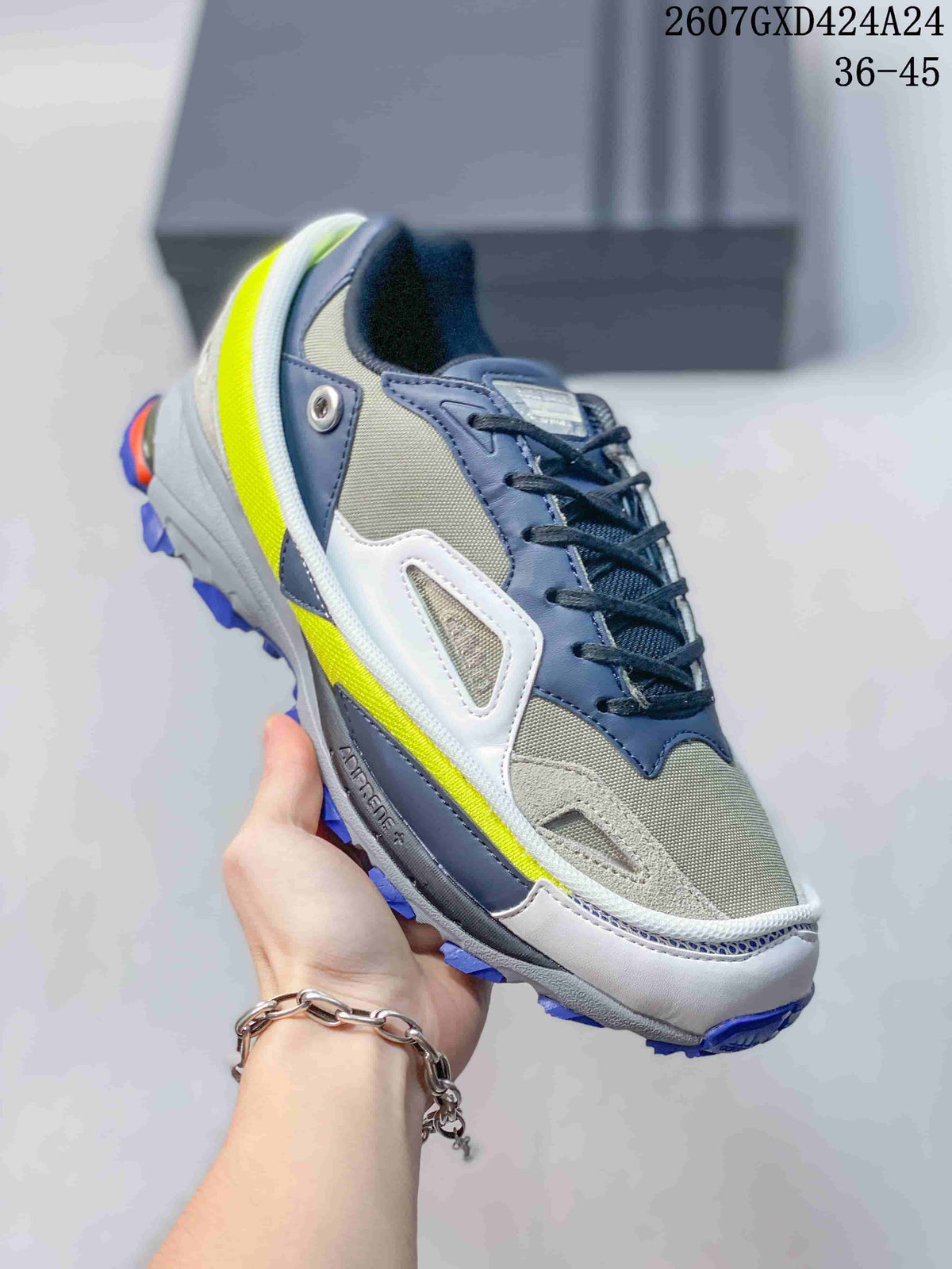 Angled side view of the low-top sneaker showing its layered upper, lace closure, neon yellow accent and blue outsole.