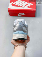 Rear view of a silver and white Nike P-6000 sneaker with pale blue heel accents