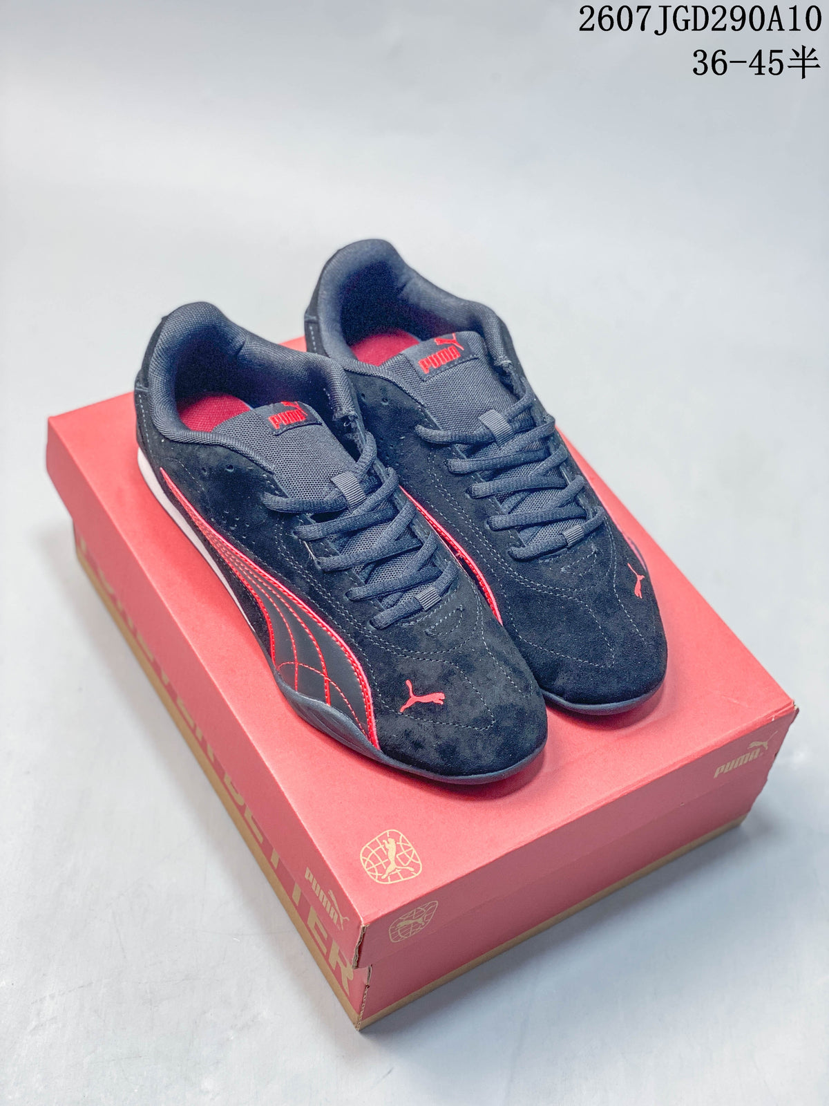 Pair of black and red Puma low-top sneakers displayed on a red shoebox.