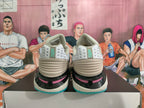 Rear view of gray-blue Nike basketball shoes with pink accents and turquoise outsole edges.