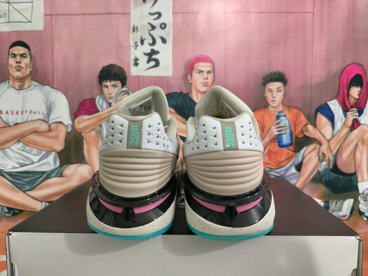 Rear view of gray-blue Nike basketball shoes with pink accents and turquoise outsole edges.