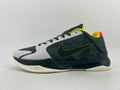 Side view of a dark green and gray Nike low-top sneaker with yellow accents and an off-white outsole