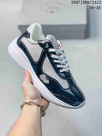 Black and white Prada America's Cup low-top sneaker with glossy overlays and textured panels.