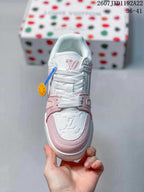 Top view showing the embossed monogram toe panel, pink trim and white laces.