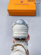 Rear view of a white and grey low-top sneaker