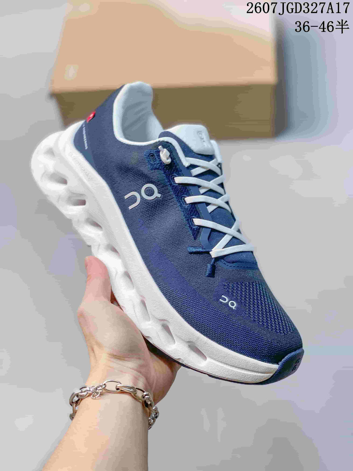Angled side view of a navy and white On sneaker showing the mesh-like upper, side branding, and sculpted sole.